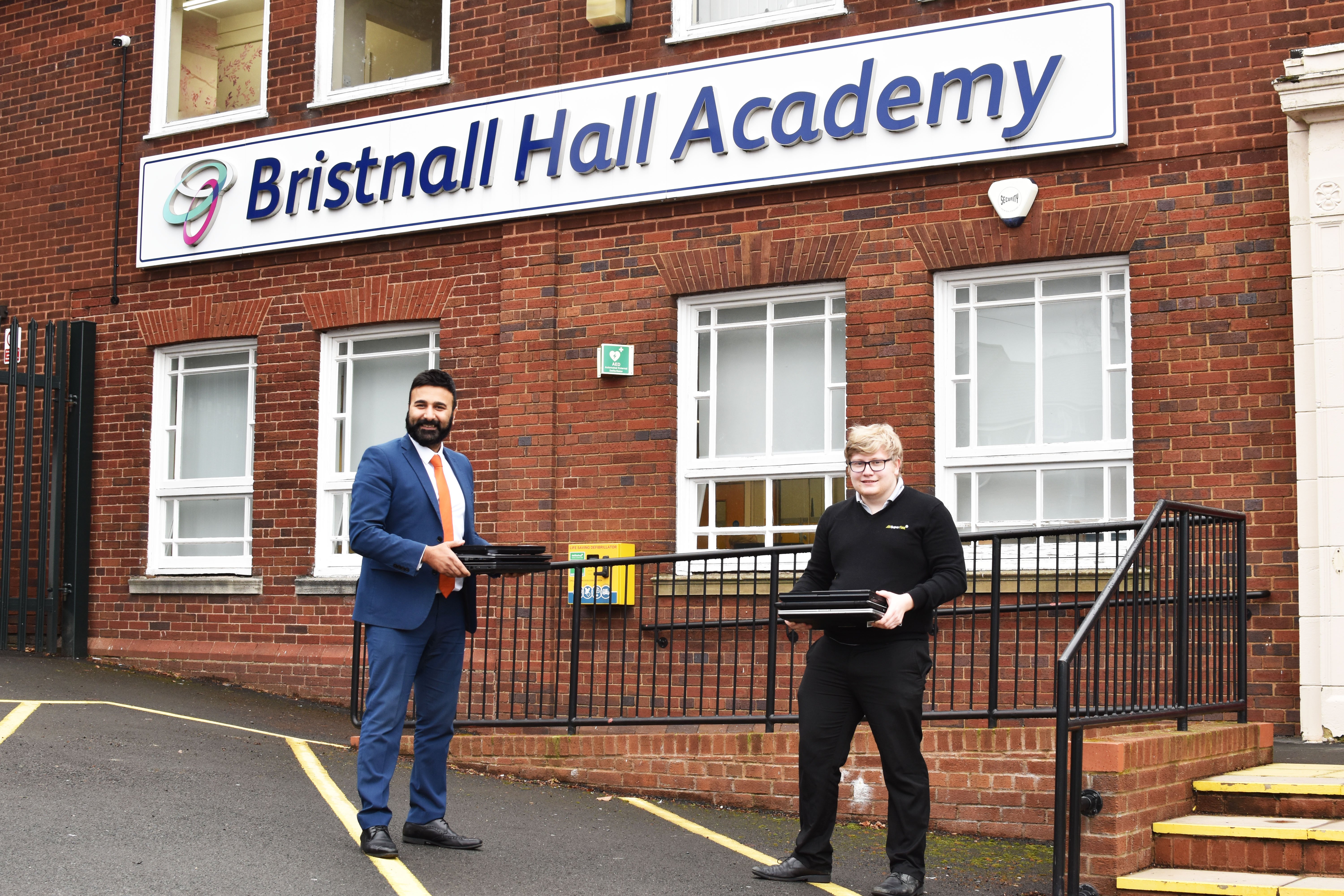 Kully Uppal, Principal, Bristnall Hall Academy. Toby Nicholls, Technician, Superfast IT - donating laptops